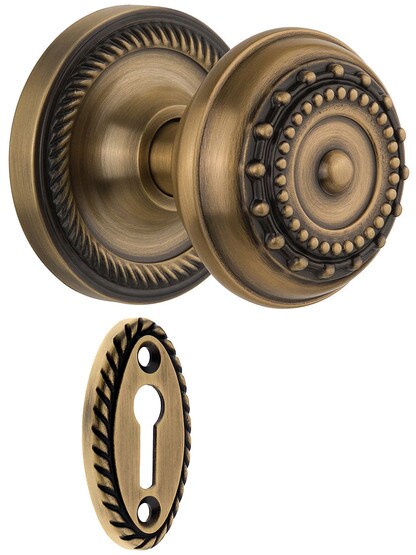 Rope Rosette Style Mortise Lock Set With Meadows Door Knobs in Antique Brass.